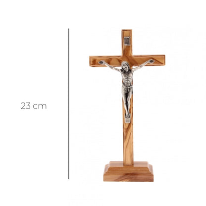 Crocifisso in legno d'ulivo e corpo in metallo con base. Altezza 23 cm
