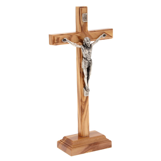 Crocifisso in legno d'ulivo e corpo in metallo con base. Altezza 23 cm
