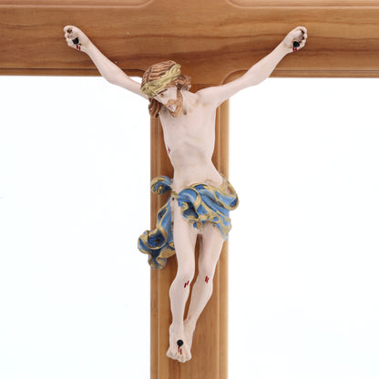 Crocifisso in legno d'olivo, corpo in resina decorata. Altezza 27 cm