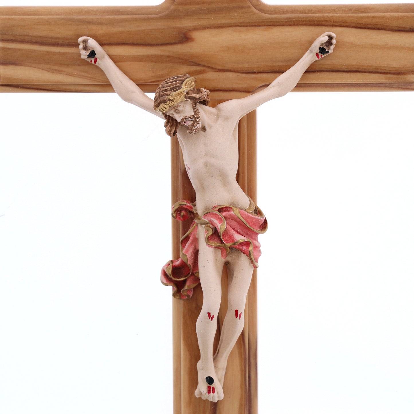 Crocifisso in legno d'olivo, corpo in resina decorata. Altezza 27 cm
