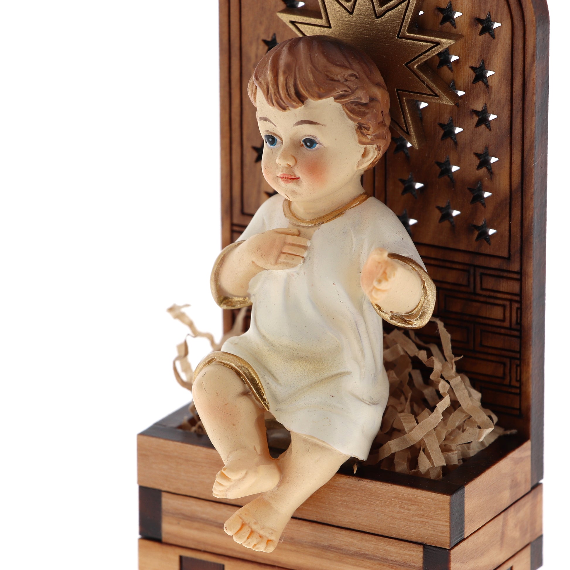 Base in legno d'olivo con stella in rilievo con Gesù Bambino seduto. Dimensioni 9,5x4,5 cm