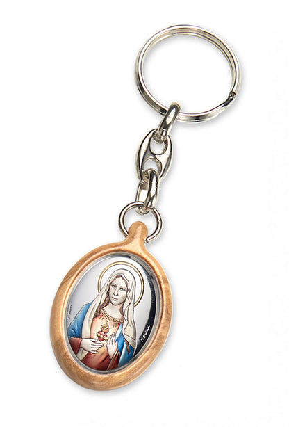 Portachiavi in legno d'olivo con placca in argento laminato colorata. Dimensioni 4,2x2,8 cm