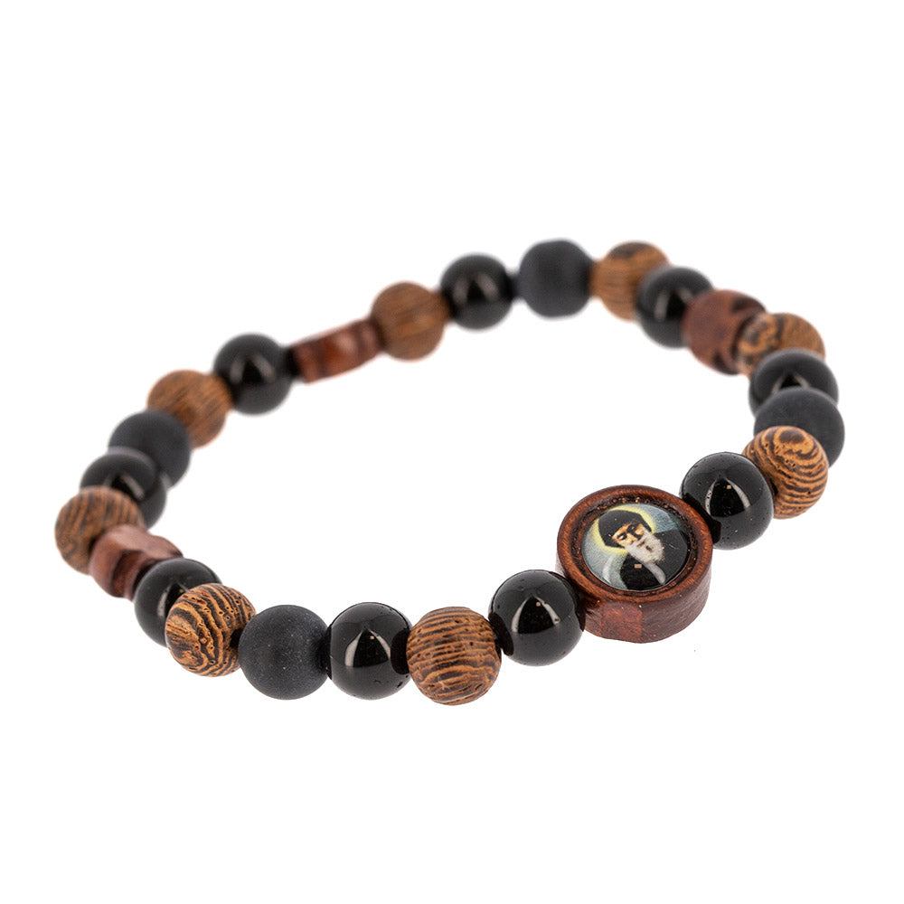Bracciale elastico San Charbel con grani in legno lavorato e croci